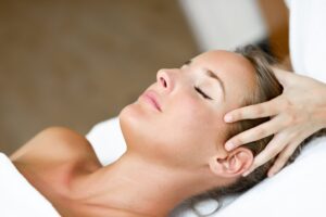 Home Woman receiving a head massage at the spa